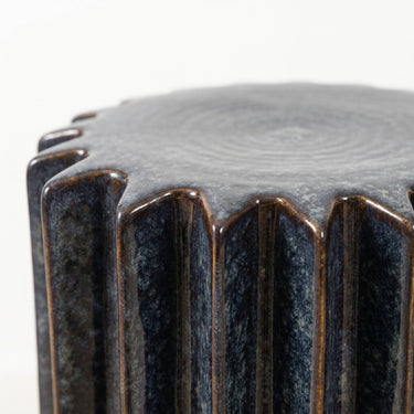 Cobalt Ridge Side Table deep vertical ridges, finished in a reactive glaze blending dark navy blue with metallic bronze tones. 