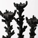 Three black coral-shaped candle holders with textured, branching stems and circular cup-like tops, shown against a plain light gray background.