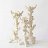 Three coral-shaped decorative candle holders in an off-white textured material, arranged on a plain white surface against a white background.