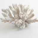 White artificial coral decorative object with a textured, branching structure.