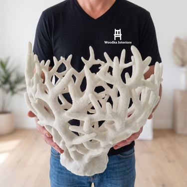 Person in a Woodka Interiors shirt holding the oversized white decorative Coralline Bowl to show its size.