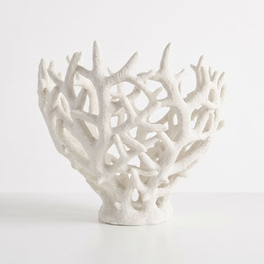 Large white decorative coralline bowl with an open-branching pattern on a stepped base.