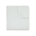 Quilt blanket in off white with a quilted texture.