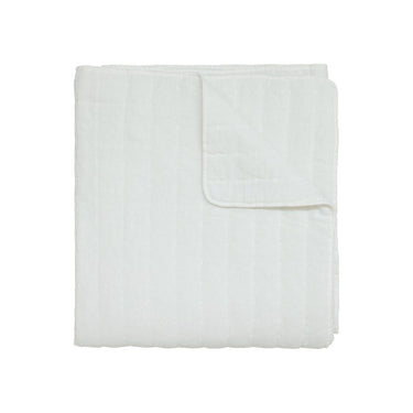 Quilt blanket in off white with a quilted texture.