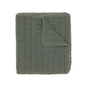 A  quilted cotton blanket in a muted sage green colour.