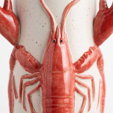 Red crayfish ceramic vase with a glossy red crayfish wrapped around a speckled cream body