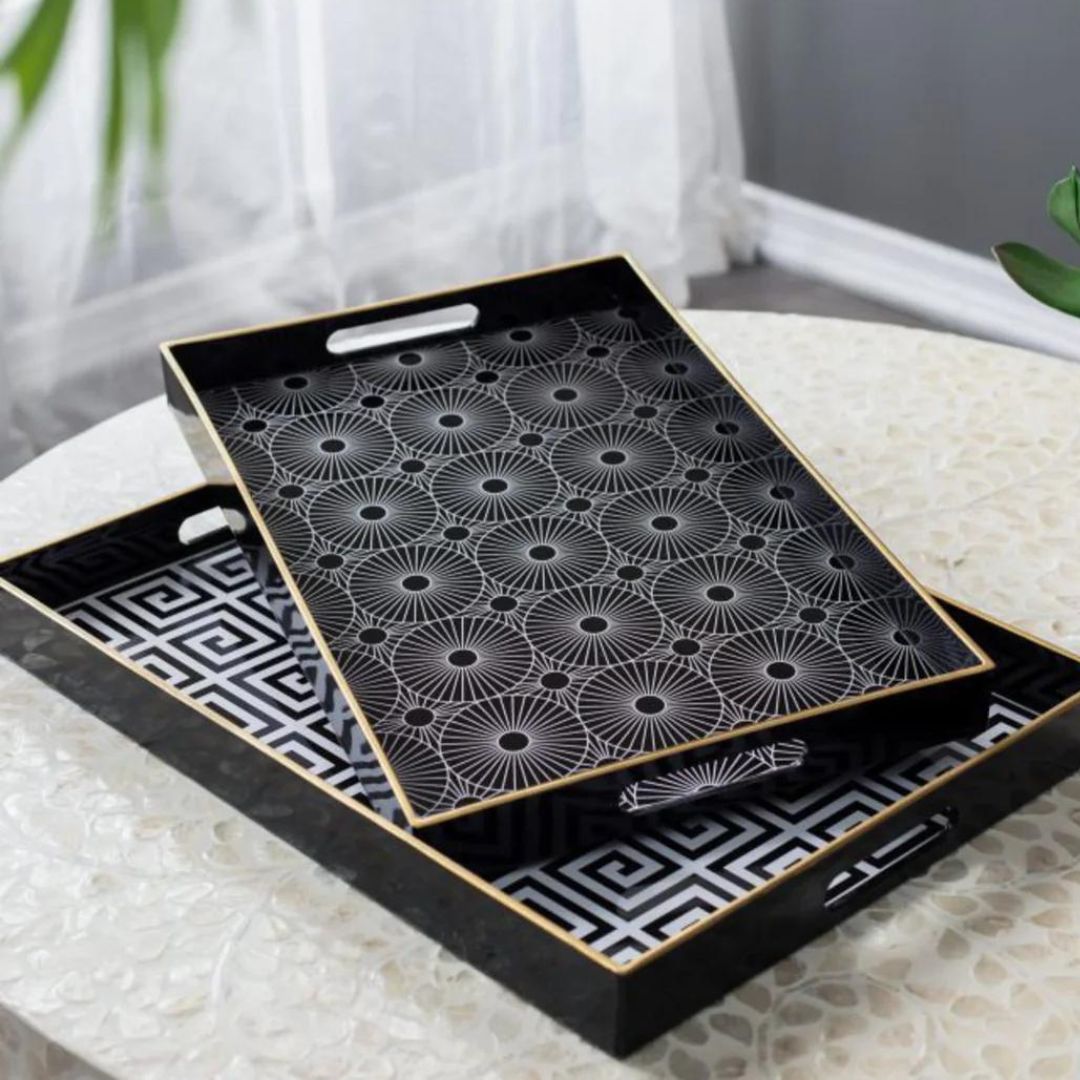 Two black trays with geometric patterns