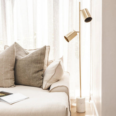 Devotion Floor Lamp styled in a contemporary living room interior.