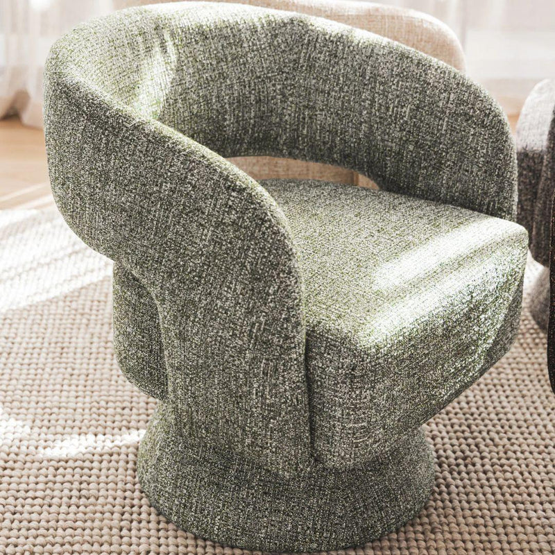 Diane swivel chair upholstered in green fabric styled in a lounge setting