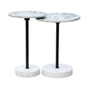 A pair of nesting side tables with round white marble tops and black metal pedestal bases on a white background.