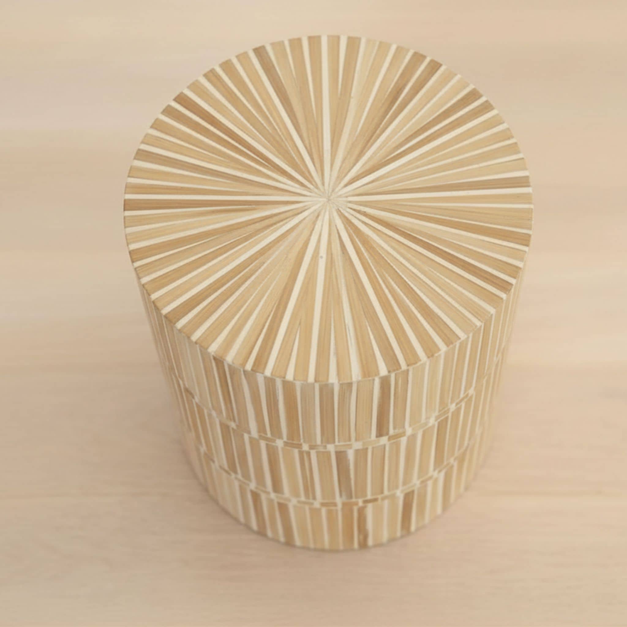 rounded form and a natural mother of pearl finish of the dune side table