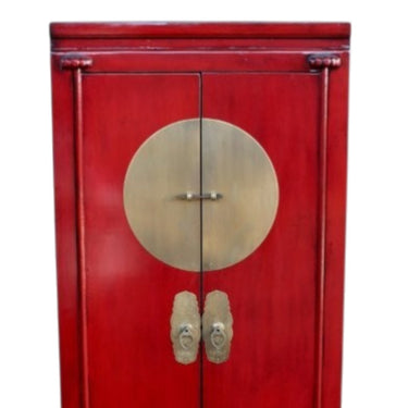 Authentic solid brass central hardware on a red lacquer Dynasty tall cabinet.