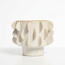 Eclipse sculptural flower plant pot with a textured pattern featuring a pedestal base in a warm ivory cream colour.