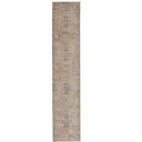 Long runner rug with a distressed traditional pattern in beige, taupe, and muted blue-grey tones in durable polyester.