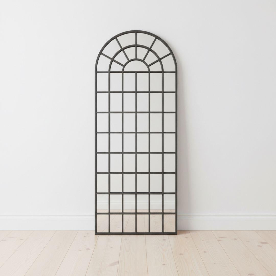 Fenestra Arched Mirror styled as a tall decorative mirror in a modern interior space
