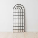 Fenestra Arched Mirror styled as a tall decorative mirror in a modern interior space