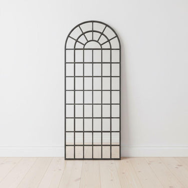 Fenestra Arched Mirror styled as a tall decorative mirror in a modern interior space