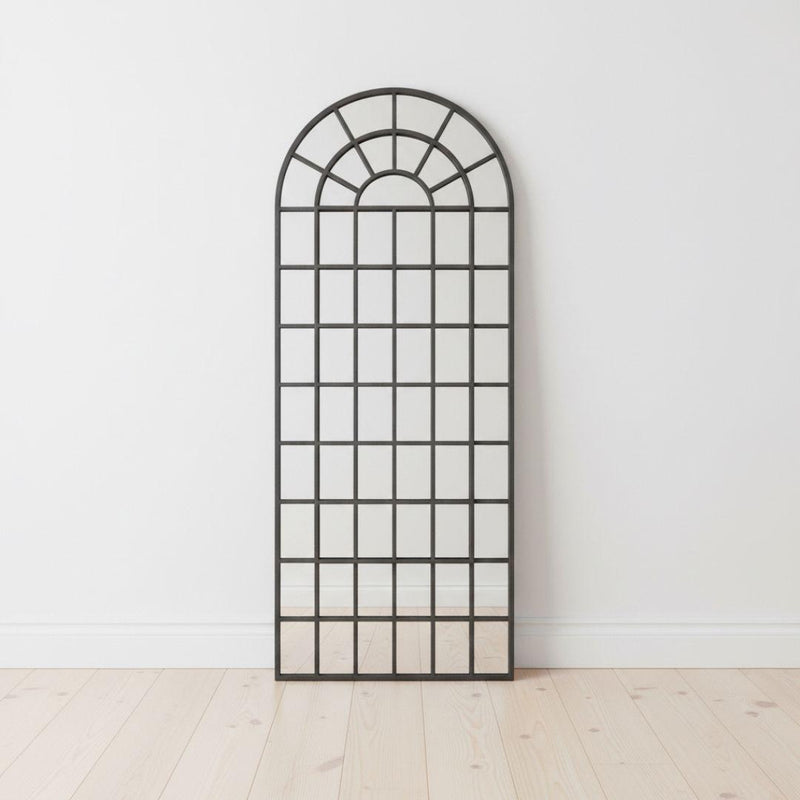 Fenestra Arched Mirror styled as a tall decorative mirror in a modern interior space