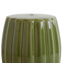 Detailed close-up of the glossy green glaze and sculpted fluted surface on the ceramic stool.