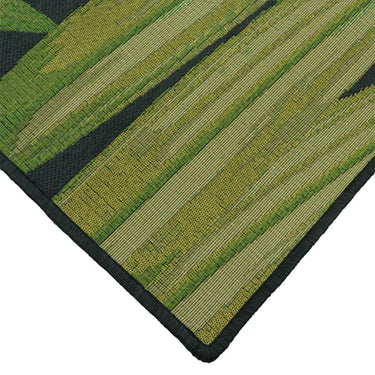 Folia Black Rug showcasing tropical botanical motif