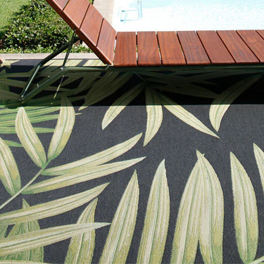 Folia Black Rug styled on outdoor patio poolside