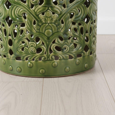 Detail shot of the stud trim along the base of the Forest Ceramic Stool, showing the decorative relief beading against the high-gloss dark green finish