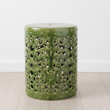 Forest Ceramic Stool styled alone in a minimal white room, used as a side table 