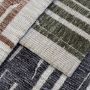 Close-up of glimpse area rugs in three colours of green, black, brown
