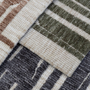 Close-up of glimpse area rugs in three colours of green, black, brown