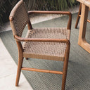 Goa Teak dining arm chair styled on outdoor patio with plush UV-resistant rope seat and back, perfect for modern outdoor entertaining