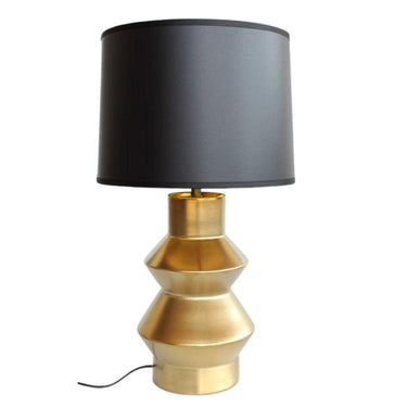 Table lamp with gold base and black shade.