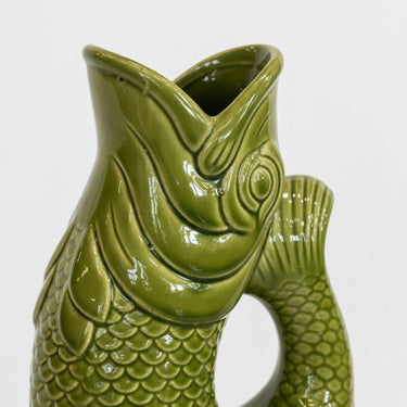 Detailed close-up of green ceramic koi jug vase