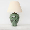 Bold emerald green ginger jar lamp styled as a sophisticated pop of colour in a bright, minimalist interior.