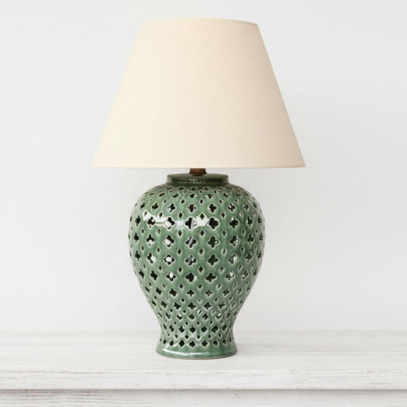Emerald green ginger jar lamp styled as a sophisticated pop of colour in a bright, minimalist interior.