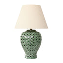 green ceramic ginger jar lamp featuring a lattice cut-out design and a neutral fabric drum shade.