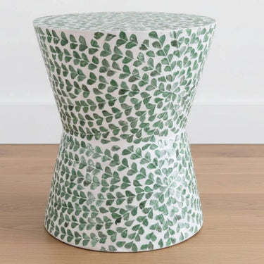 Green shell accent stool styled in a coastal living room