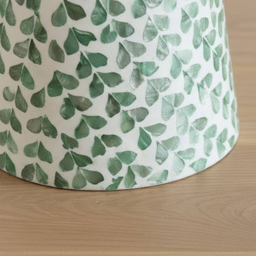 Green shell leaf detail on pedestal side table base