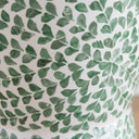 Close-up of green shell leaf pattern on accent stool