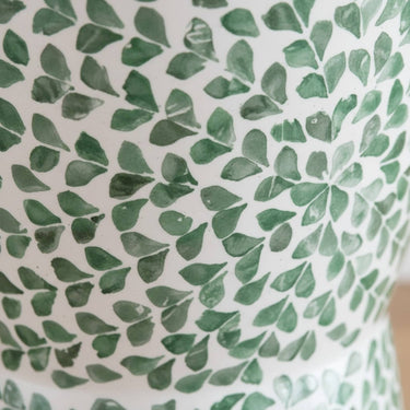 Close-up of green shell leaf pattern on accent stool