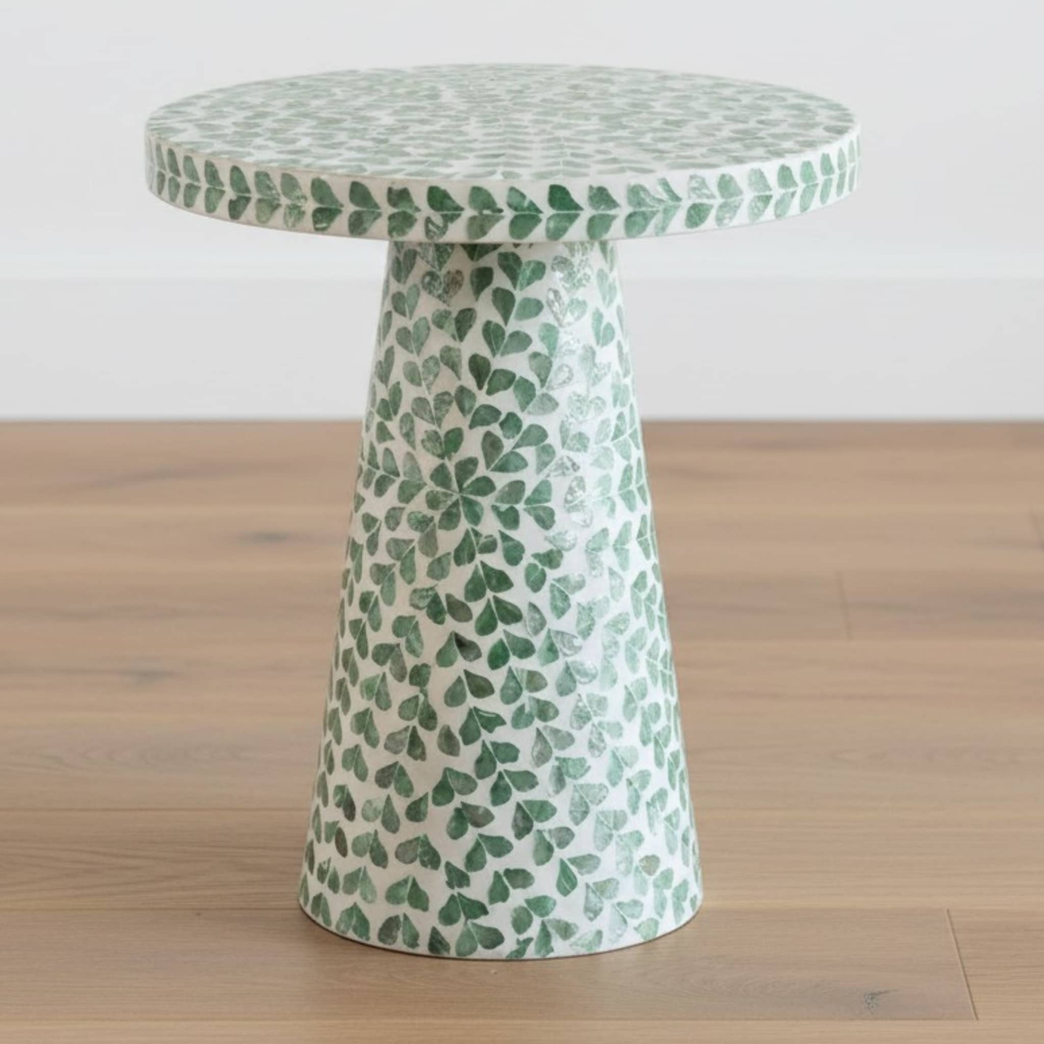 Green shell side table styled in a coastal living room