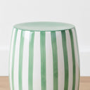 Detailed close-up of the vibrant green-on-white vertical stripes and polished glaze finish of the Green striped side table.