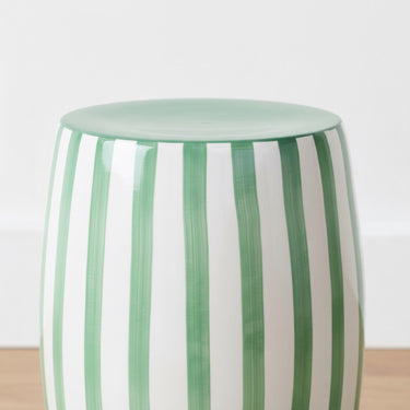Detailed close-up of the vibrant green-on-white vertical stripes and polished glaze finish of the Green striped side table.