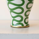 Close-up of the elegant gold trim  and high-quality ceramic construction of the Green Swirl Lamp.