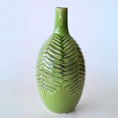 green vase with intricate leaf detailing floral arrangements.