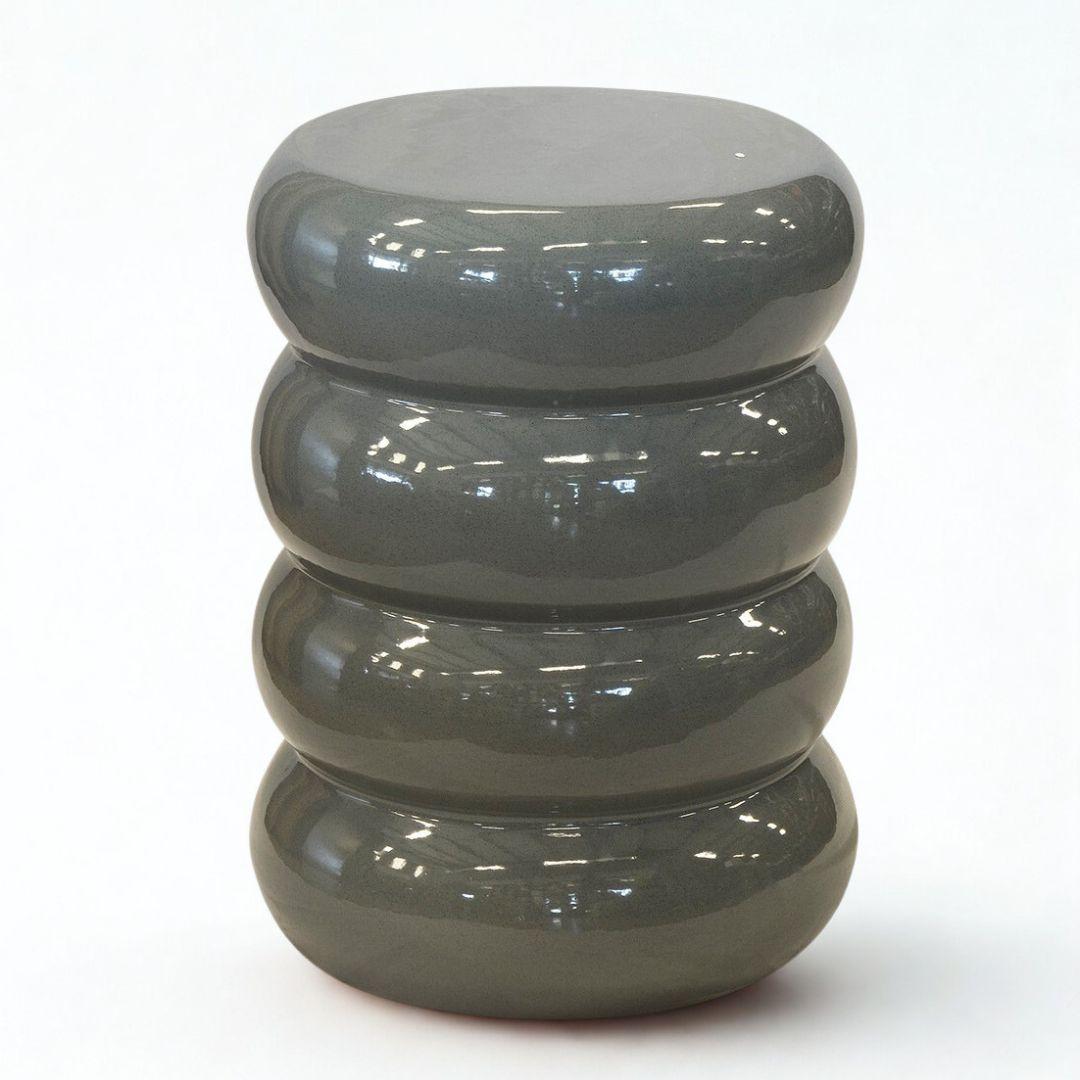 Grey ceramic side table with glossy finish and matte base detail. Sculptural side table for indoor or outdoor styling.