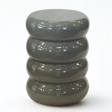 Grey ceramic side table with glossy finish and matte base detail. Sculptural side table for indoor or outdoor styling.