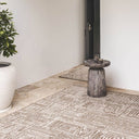 Gridlock large geometric outdoor patio rug in the brown Suntan colour in outdoor garden.