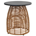 A round outdoor side table featuring a dark charcoal gray top and a natural brown woven rattan base, shown against a plain white background.