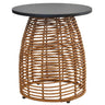 A round outdoor side table featuring a dark charcoal gray top and a natural brown woven rattan base, shown against a plain white background.