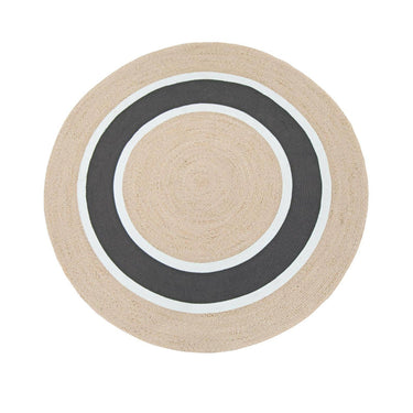 A round rug with concentric circular stripes in natural beige, white, and dark charcoal gray.